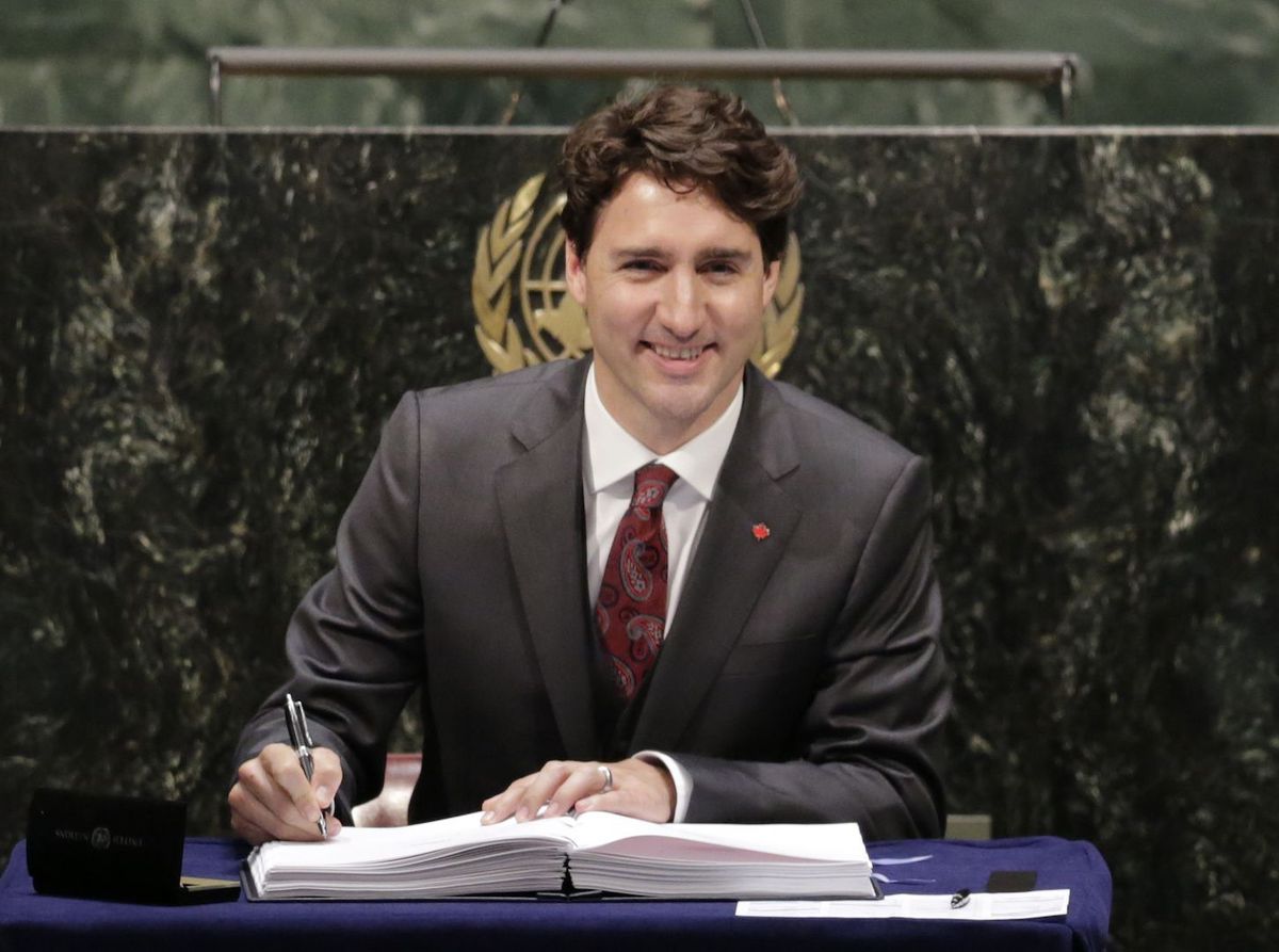 Trudeau signs the Paris Climate Agreement in April 2016.