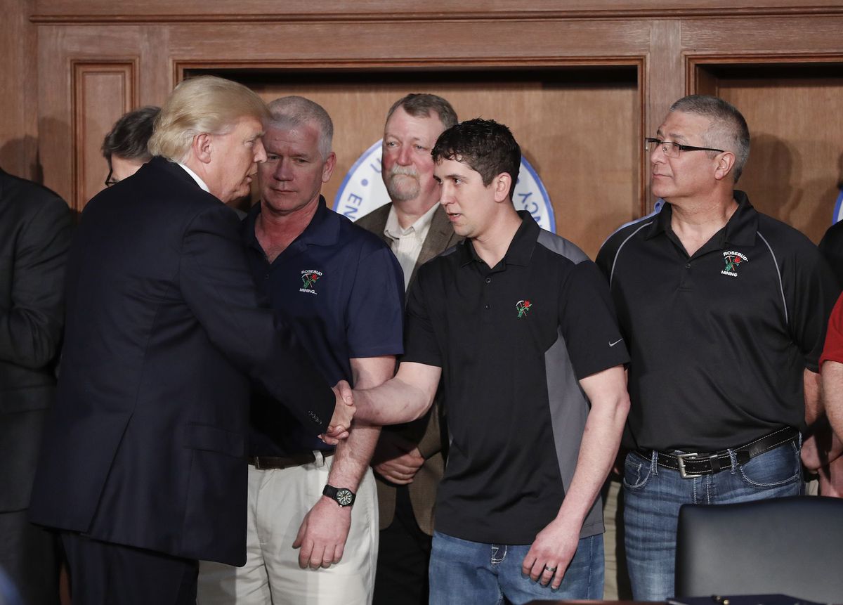 President Donald Trump shakes hands with employees from Rosebud Mining Company.