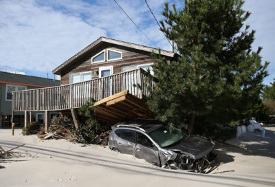 A house and car on Long Beach Island damaged in 2012&nbsp;by Hurricane&nbsp;Sandy.
