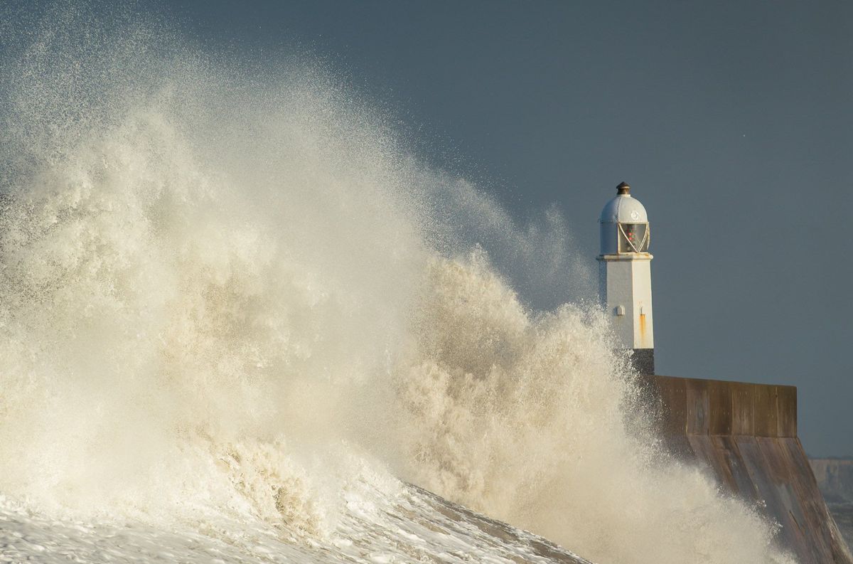 Waves batter the sea wall and the lighthouse at Porthcawl, south Wales as storm Doris hits the UK in February 2017.