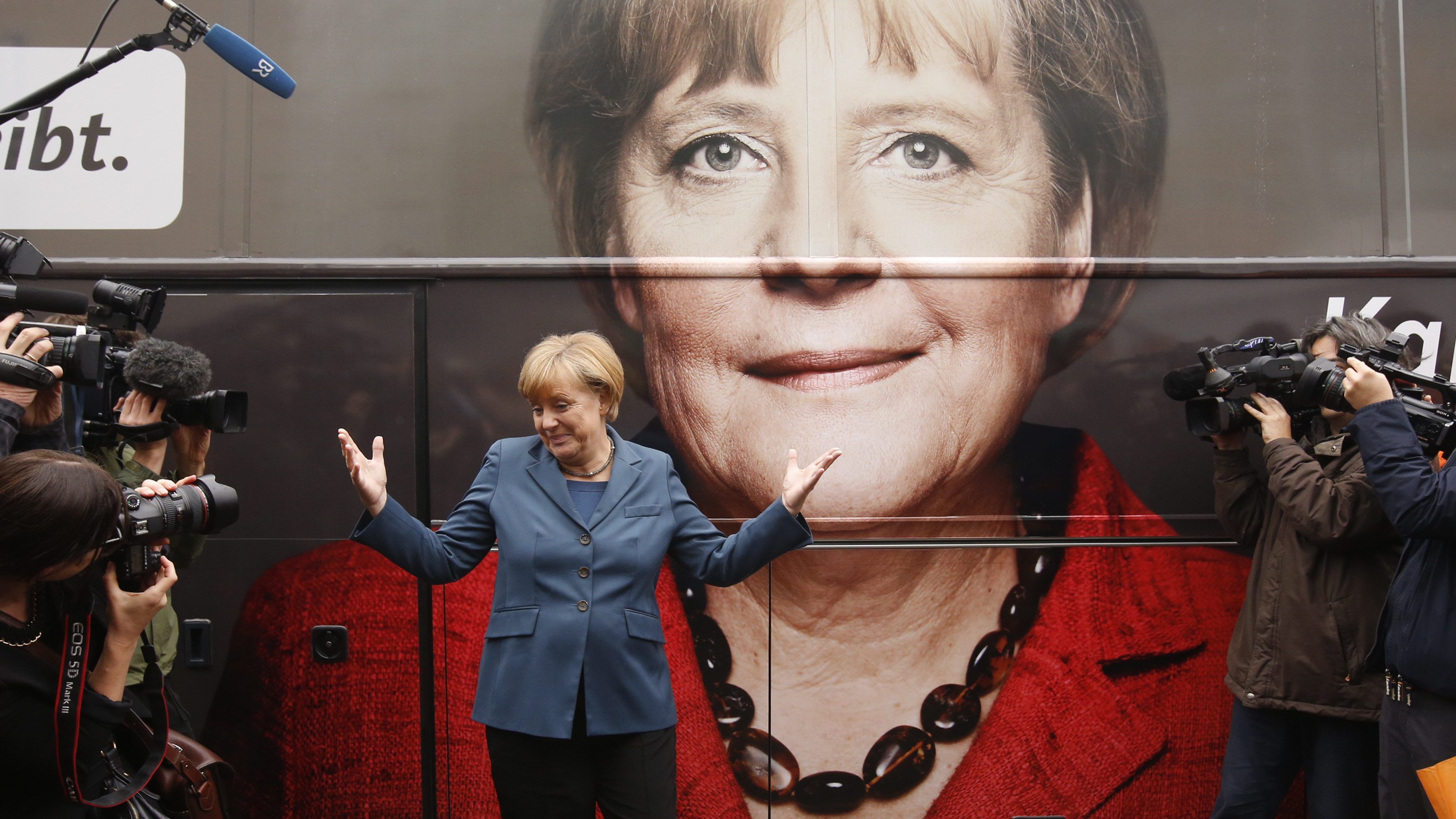 German Chancellor Merkel and leader of the CDU party stands in front of her election campaign tour bus at the CDU's headquarters in Berlin