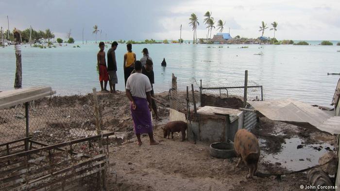 People on Kiribati look at the water