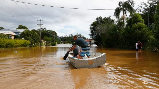 The new normal? Residents paddle down a street in Murwillumbah in March after heavy rains led to flash flooding.