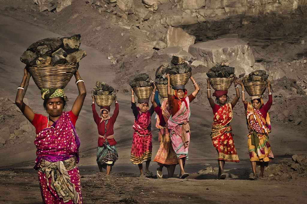 Indian villagers, illegally scavenging coal from a nearby mine.