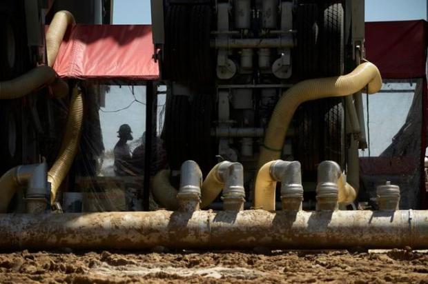 A fracking crew member works inside ...