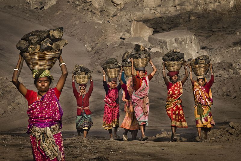 Scavening coal from an open-cast coal mine in Dhanbad, Jharkhand, India