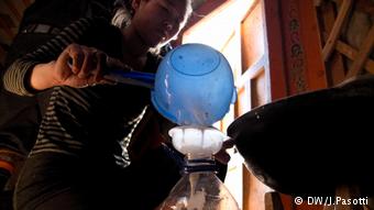 A young woman pours camel milk into a bottle inside her ger, a typical nomad's tent in Mongolia (Photo: Jacopo Pasotti)
