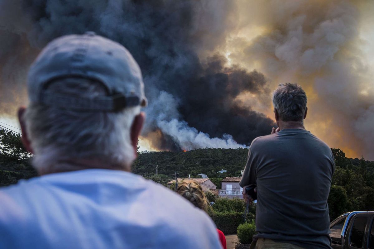 Fires burn around the picturesque hilltop town of Bormes-Les-Mimosas, France.