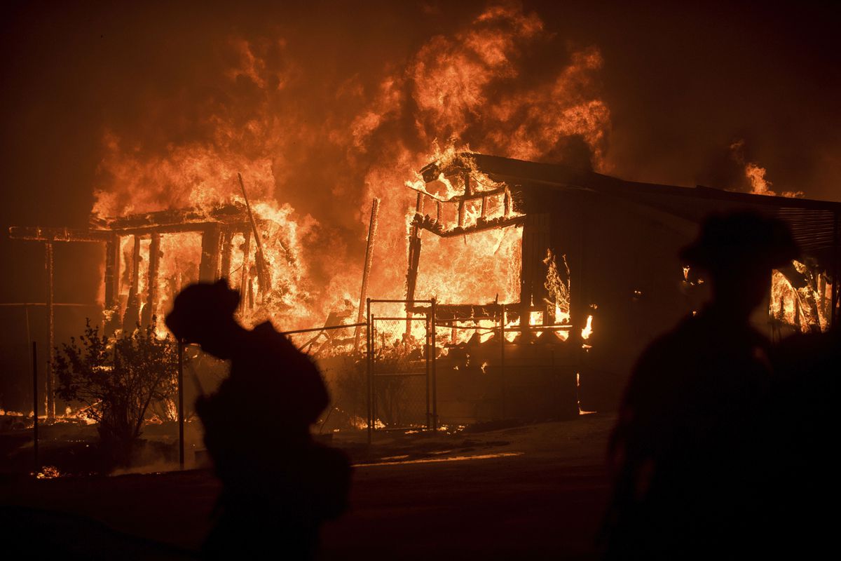 Flames from a wildfire consume a residence near Oroville, Calif., on July 9, 2017.