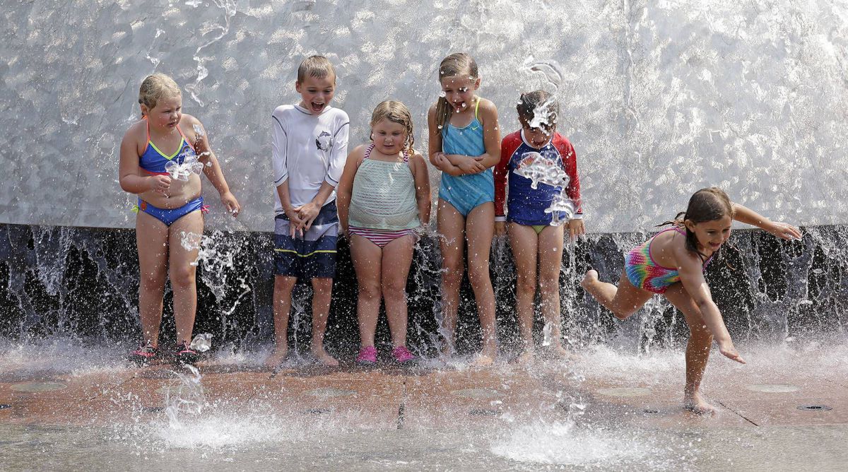 Children playing in a fountain in Seattle during a heat wave on Aug. 2, 2017.
