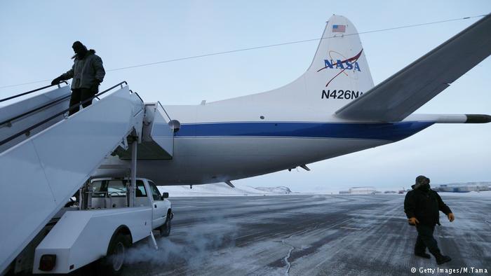 Crew members prepare the retrofitted 1966 Lockheed P-3 aircraft for takeoff from Thule Air Base on March 27, 2017 in Pituffik, Greenland.