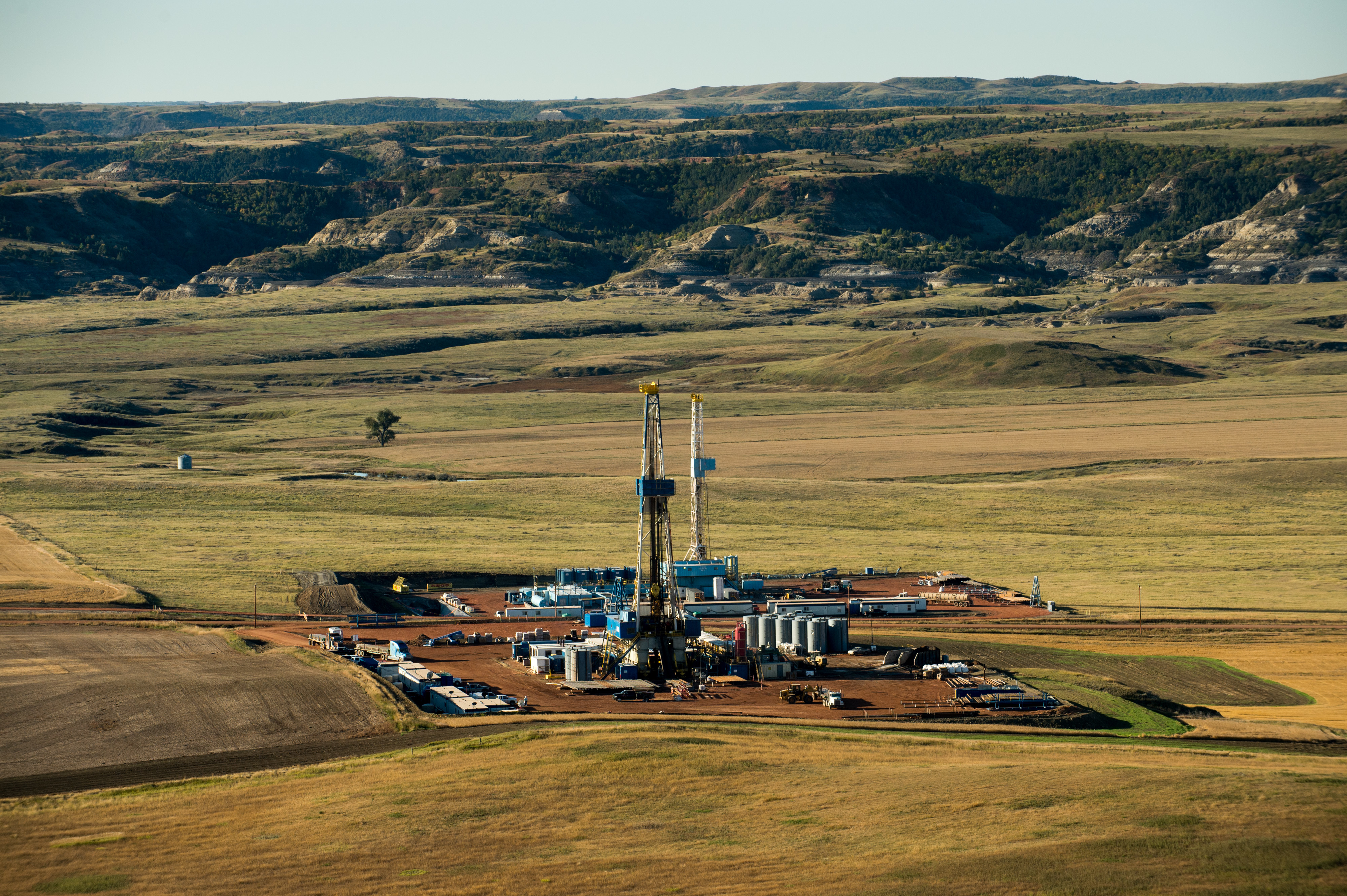 Photo of oil rigs sit just outside of Theodore Roosevelt National Park near Watford City, North Dakota.