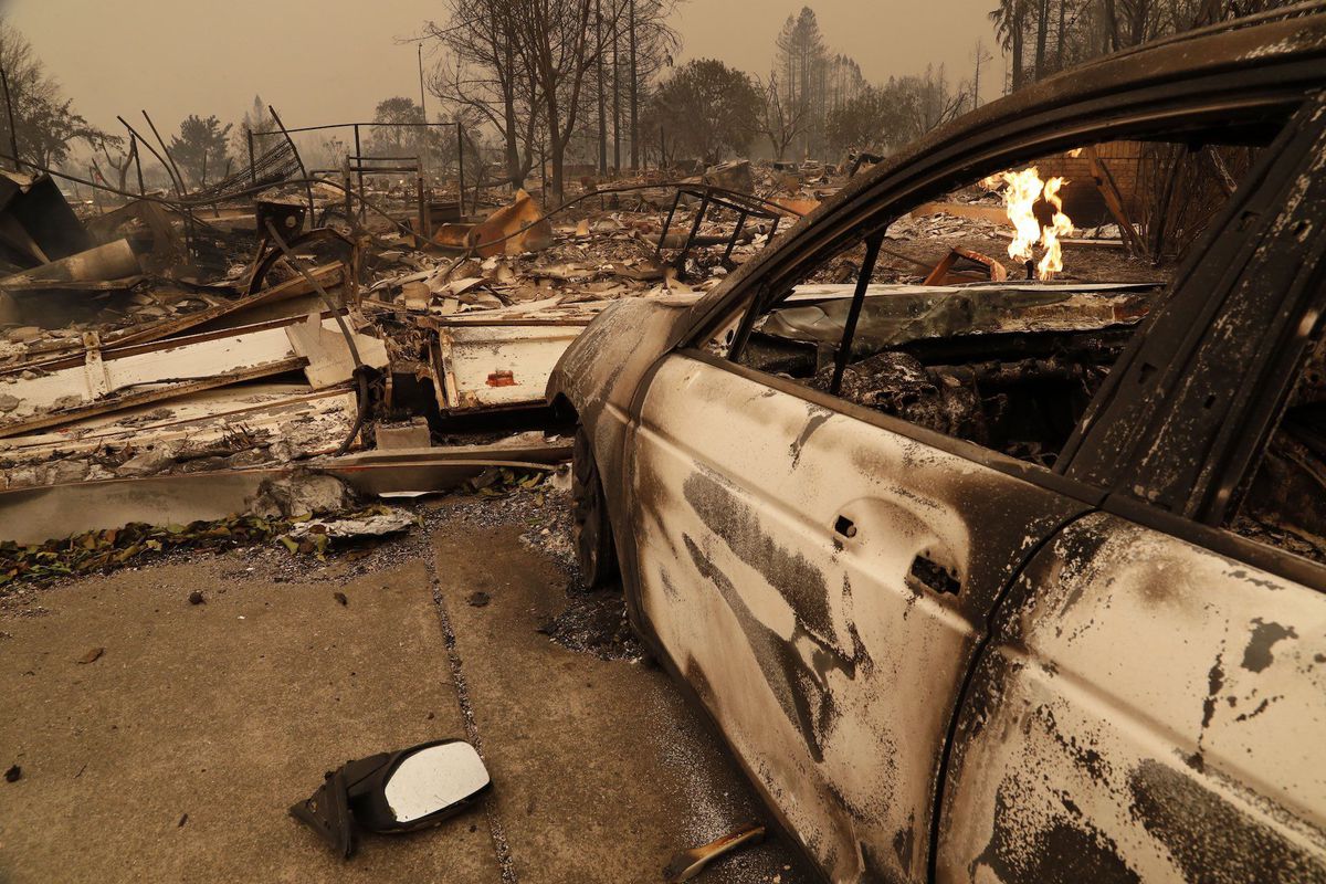 A burnt out car sits in front of a home destroyed by a wildfire in Santa Rosa, California, on Oct. 9, 2017.