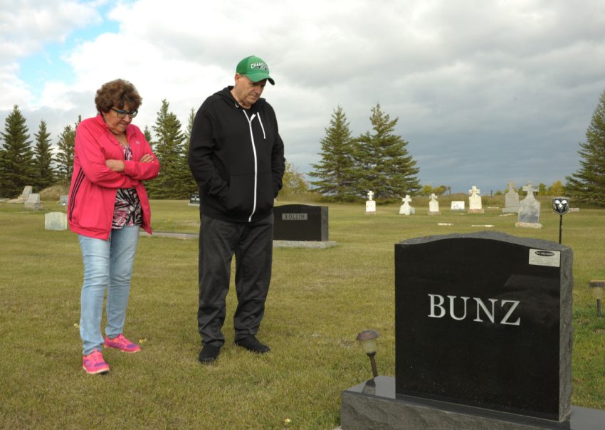 Dianne and Allan Bunz visit the gravesite of their son, Michael, who was killed by H2S gas while working near his home in Wawota, Sask. "We knew aout H2S but I wasn't aware that he was going on site and doing the testing," Dianne says. 