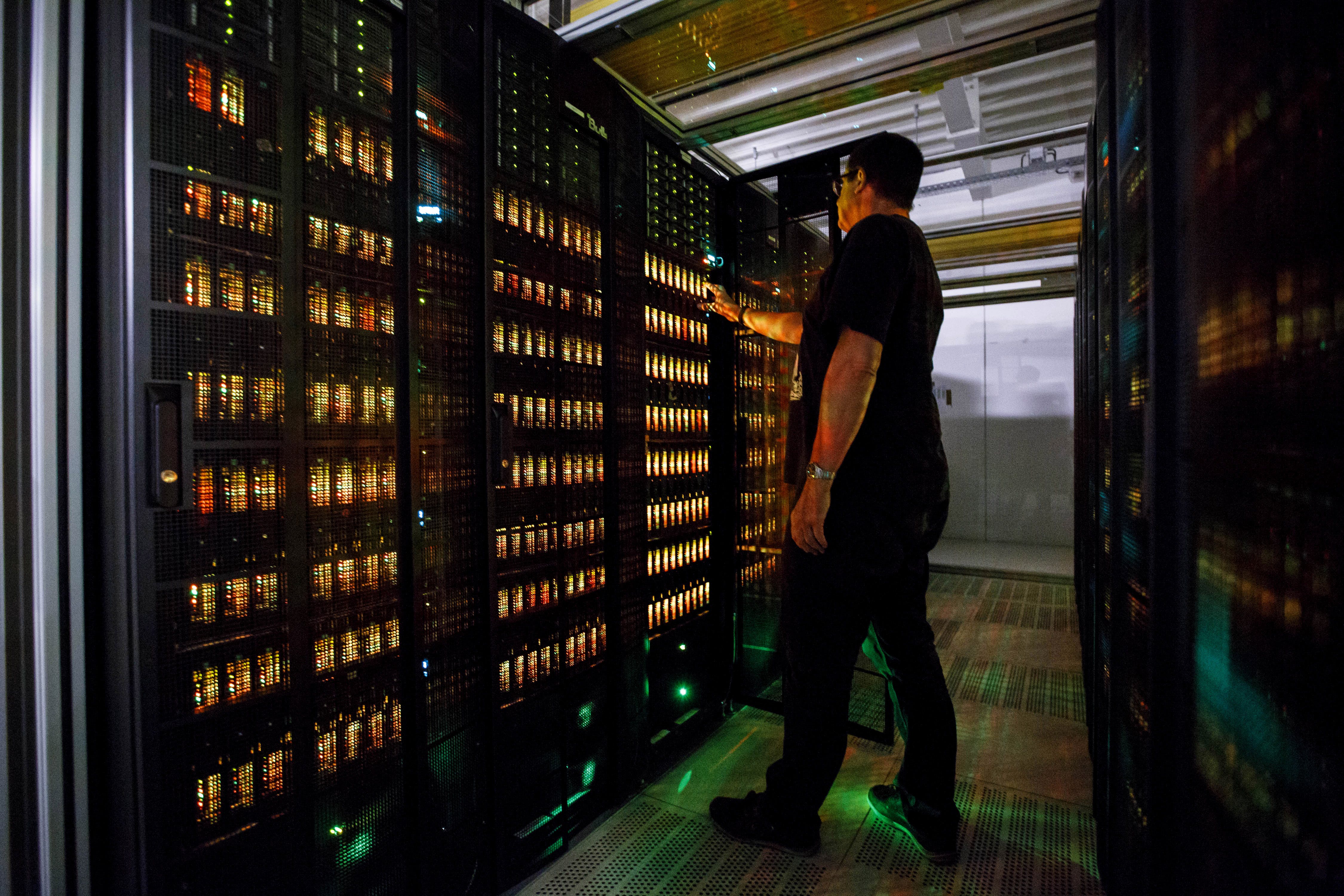 HAMBURG, GERMANY - JUNE 07: An employee of the German Climate Computing Center (DKRZ, or Deutsches Klimarechenzentrum) poses next to the "Mistral" supercomputer, installed in 2016, at the German Climate Computing Center on June 7, 2017 in Hamburg, Germany. The DKRZ provides HPC (high performance computing) and associated services for climate research institutes in Germany. Its high performance computer and storage systems have been specifically selected with respect to climate and Earth system modeling. With a total of 100,000 processor cores, Mistral has a peak performance of 3.6 PetaFLOPS. With a capacity of 54 PBytes, its parallel file system is currently one of the largest in the world. The DKRZ's robot-operated tape archive has currently a capacity of 200 petabytes and allows for long-term archiving of climate simulations such as those carried out with respect to reports by the Intergovernmental Panel on Climate Change. (Photo by Morris MacMatzen/Getty Images)