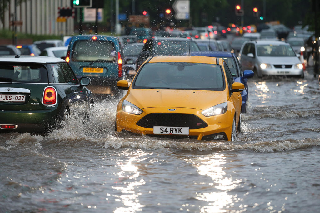 MRNMGT Traffic driving through deep flood water, Birmingham UK.