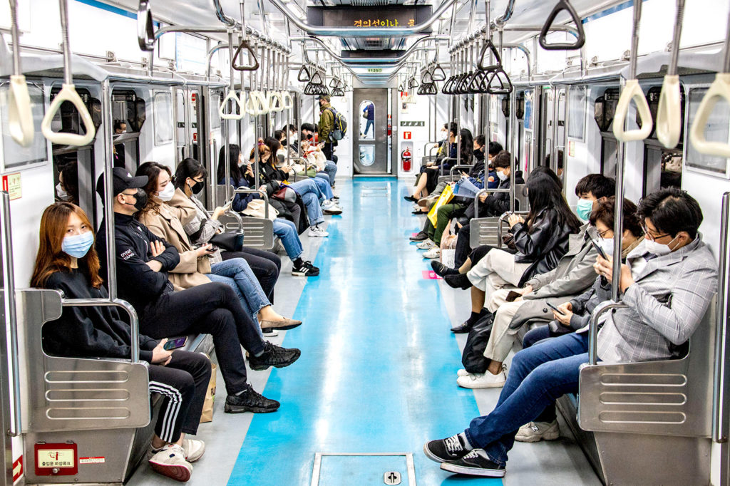 Commuters wear protective masks during the coronavirus pandemic, Seoul, South Korea, 28 March 2020. Credit: dbimages / Alamy Stock Photo. 2BAPB88