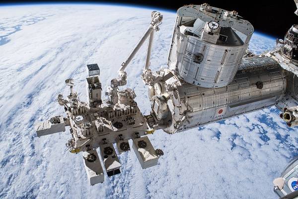 image of exterior experiment module with Earth in backdrop