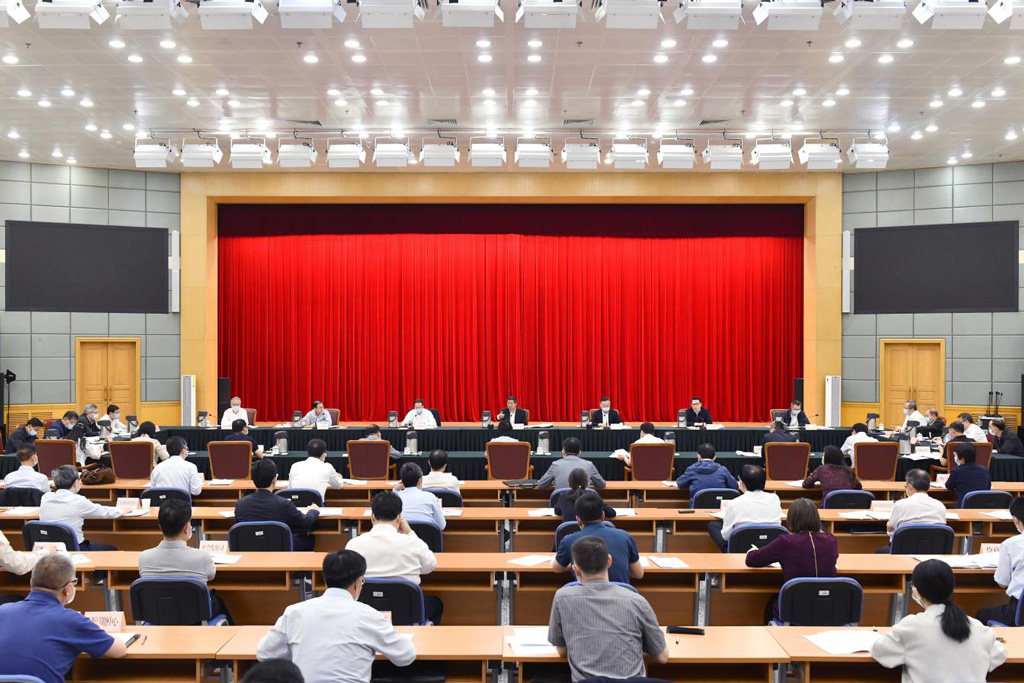 Members belonging to the office of the leaders group attend a meeting hosted by He Lifeng