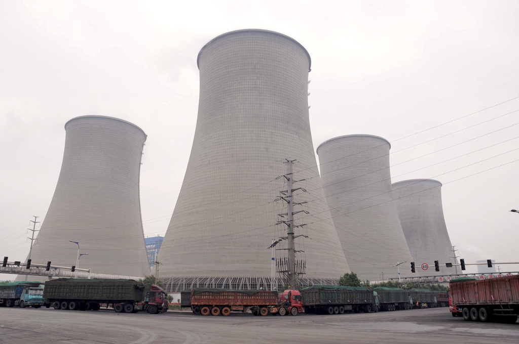 Trucks loaded with coal line up outside a coal-fired power plant of Shandong Weiqiao Pioneering Group